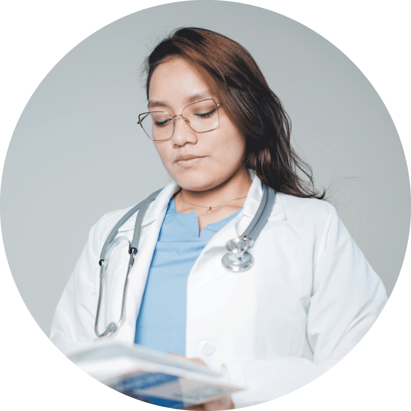 female doctor looking down at book
